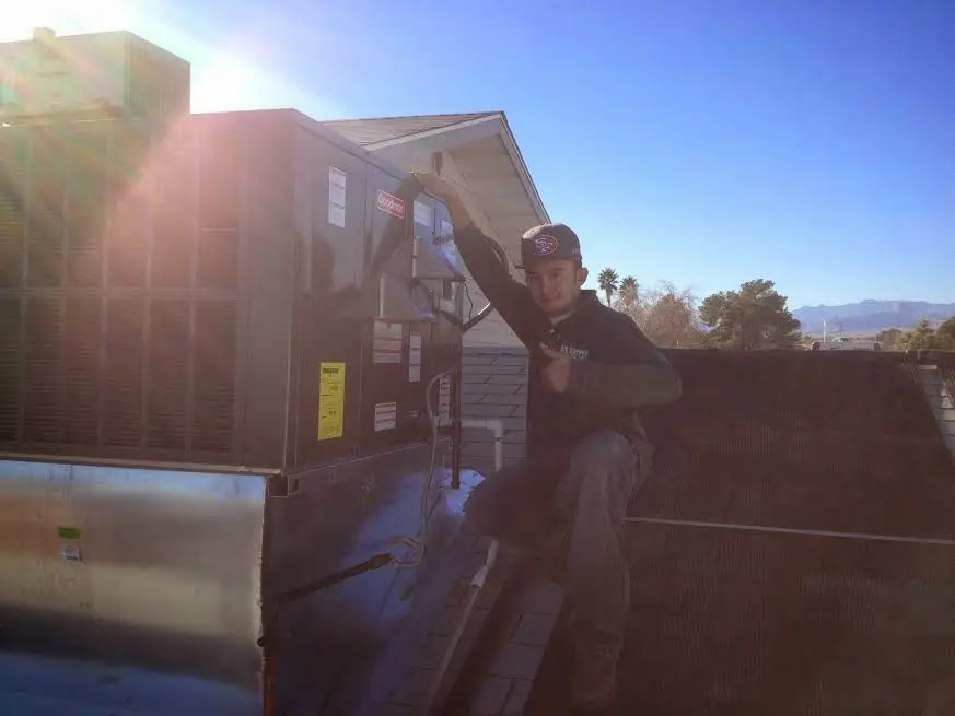 HVAC technician performing HVAC Inspection on a rooftop unit in Mocksville